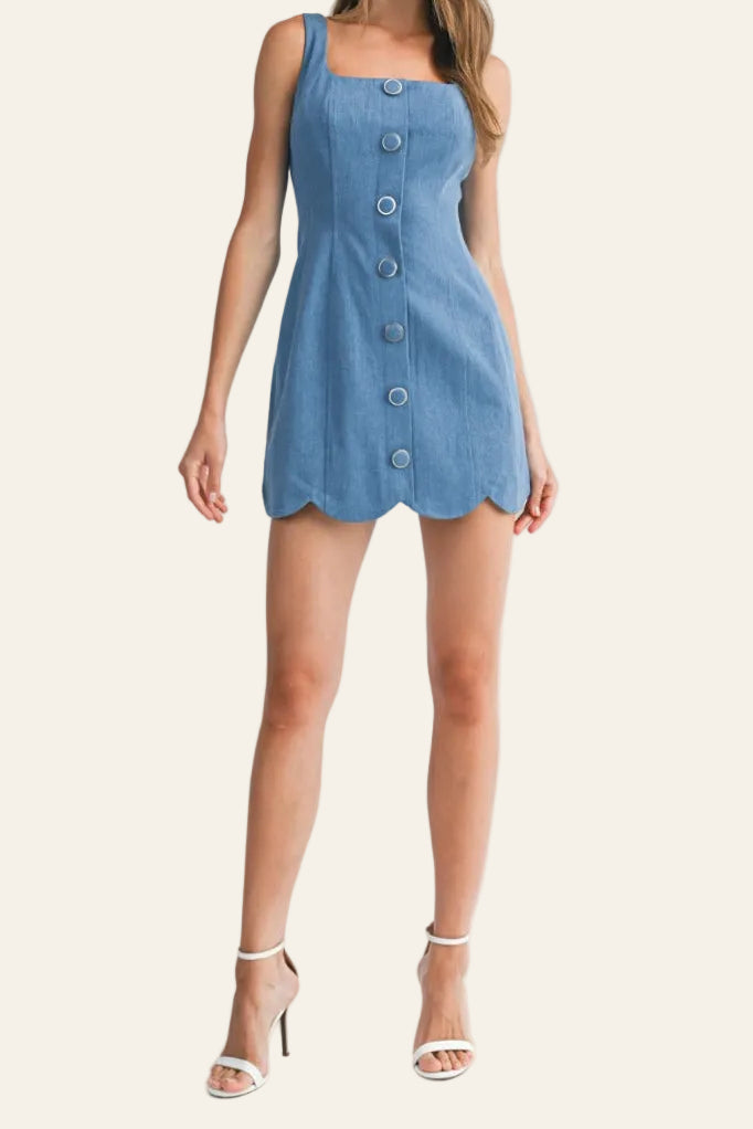 Woman wearing a blue denim dress on a white background