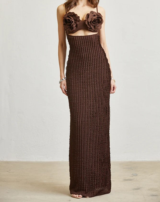 Brown knit dress with floral top on a plain background