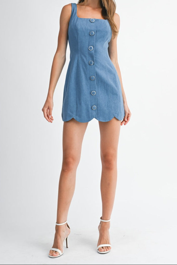 Woman wearing a blue denim dress on a white background