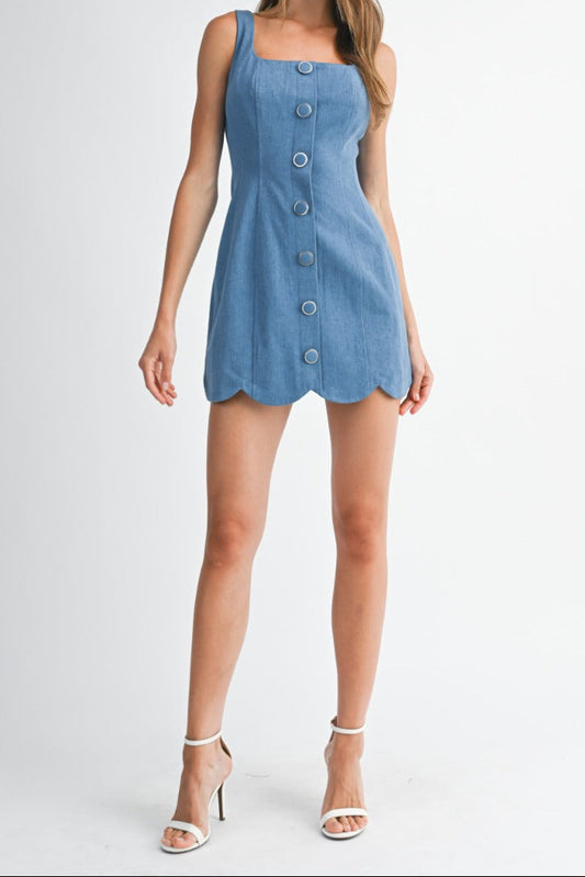 Woman wearing a blue denim dress on a white background